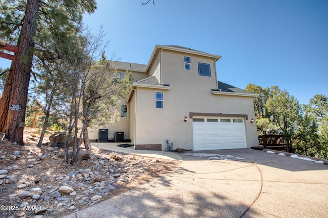 4701 S Manzanita Way, Show Low, AZ 85901 - view of property exterior with concrete driveway, an attached garage, stucco siding, and cooling unit