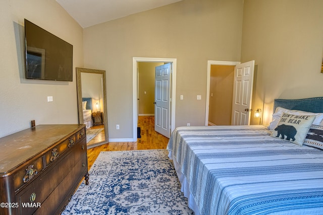 4701 S Manzanita Way, Show Low, AZ 85901 - bedroom with light wood finished floors, high vaulted ceiling, and baseboards