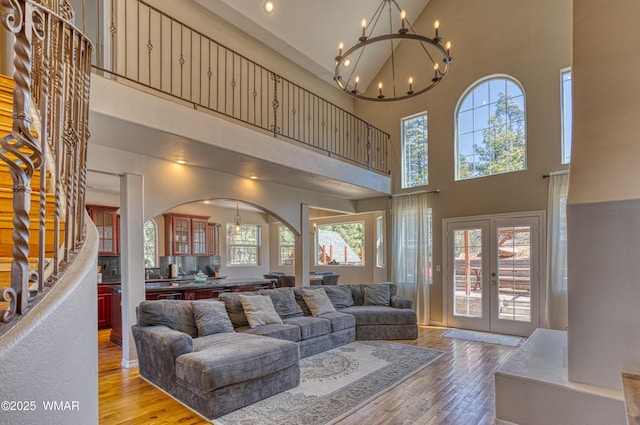 4701 S Manzanita Way, Show Low, AZ 85901 - living area featuring a towering ceiling, a chandelier, light wood finished floors, french doors, and stairway