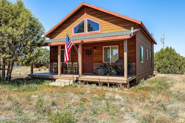 view of front of property with a porch and a shingled roof