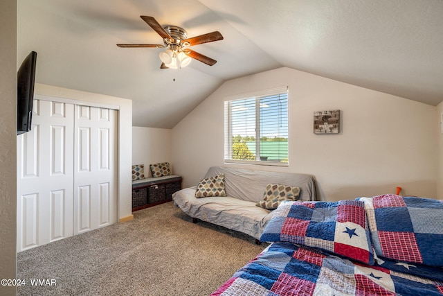 carpeted bedroom featuring a closet, vaulted ceiling, and ceiling fan