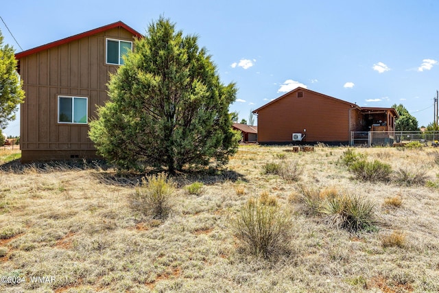 view of property exterior featuring fence and board and batten siding