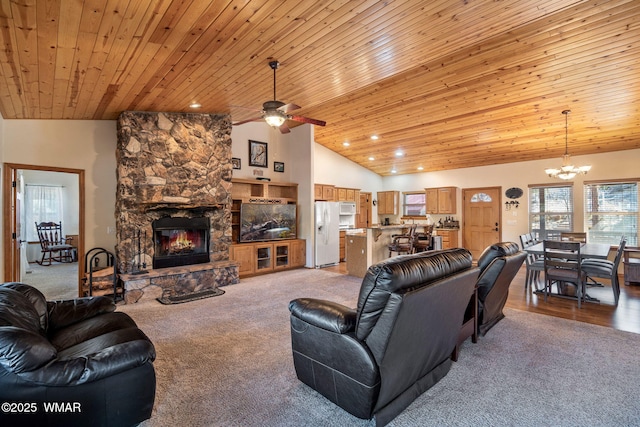 living area featuring high vaulted ceiling, ceiling fan with notable chandelier, recessed lighting, a fireplace, and wood ceiling