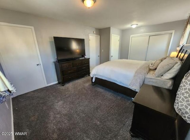 bedroom featuring dark colored carpet and a closet