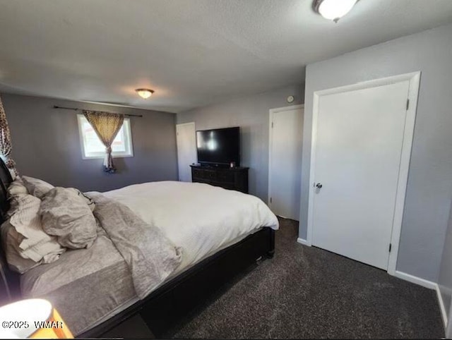 bedroom with baseboards and dark colored carpet