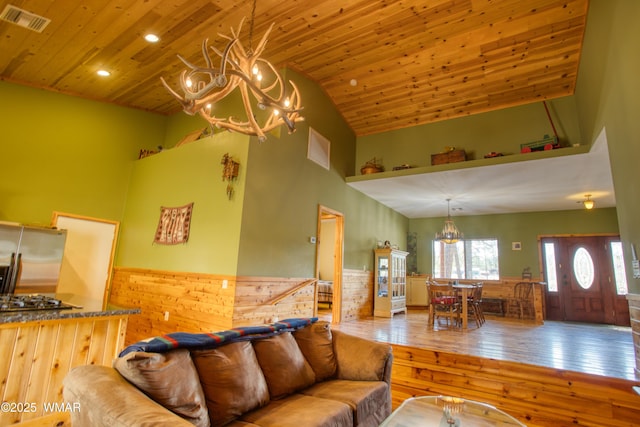5238 Buck Springs Rd, Pinetop, AZ 85935 - living area with high vaulted ceiling, a chandelier, wooden ceiling, wainscoting, and wood-type flooring