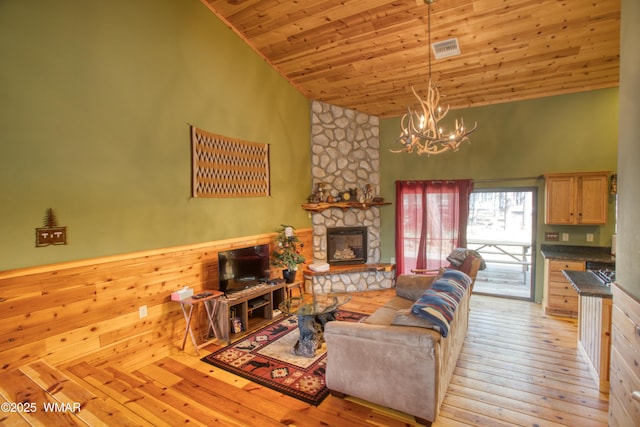 5238 Buck Springs Rd, Pinetop, AZ 85935 - living area featuring high vaulted ceiling, a chandelier, a stone fireplace, wooden ceiling, and light wood-style flooring