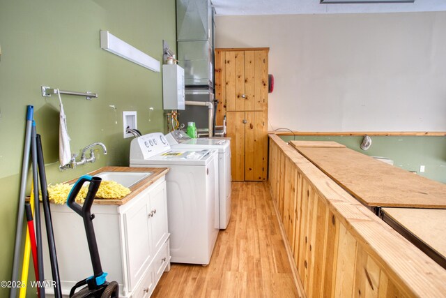 5238 Buck Springs Rd, Pinetop, AZ 85935 - washroom with cabinet space, light wood finished floors, and washing machine and clothes dryer