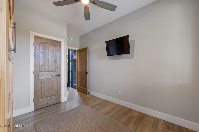 2051 N Bison Pass Ct, Show Low, AZ 85901 - unfurnished bedroom featuring baseboards, wood finished floors, and a ceiling fan