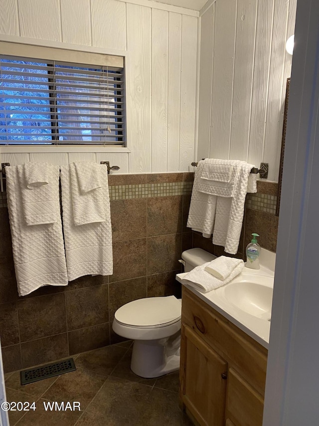 bathroom featuring toilet, tile patterned flooring, vanity, and visible vents