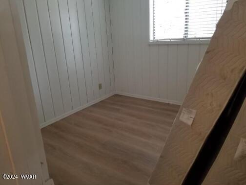 unfurnished room with light wood-style flooring and baseboards