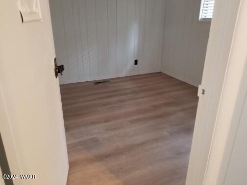 unfurnished room featuring wood finished floors