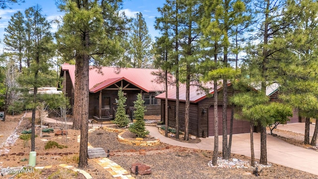 2870 W Lodgepole Ln, Show Low, AZ 85901 - view of front of property featuring a garage, metal roof, concrete driveway, and covered porch