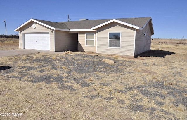 ranch-style home featuring an attached garage and concrete driveway