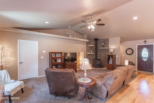7431 N Gemini Ln, Lakeside, AZ 85929 - living room with a wood stove, ceiling fan, vaulted ceiling, wood finished floors, and baseboards