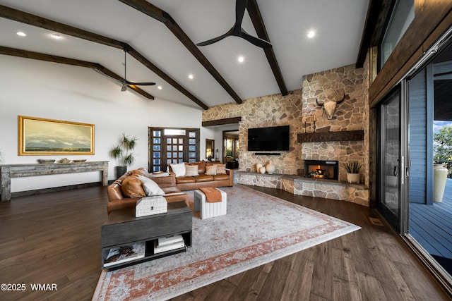 living area featuring a ceiling fan, dark wood-style floors, a fireplace, high vaulted ceiling, and beam ceiling