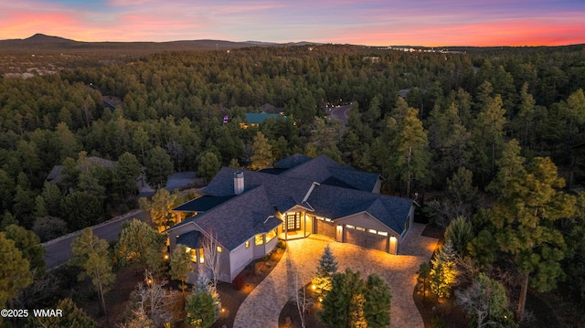 aerial view featuring a mountain view and a wooded view