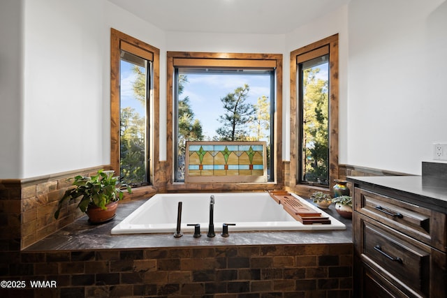 full bathroom with a healthy amount of sunlight and a garden tub