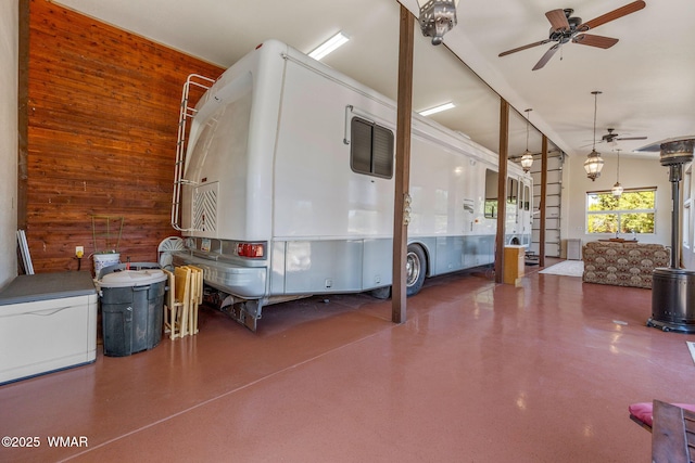 2335 Voyager Cir, Overgaard, AZ 85933 - garage with a ceiling fan and wood walls
