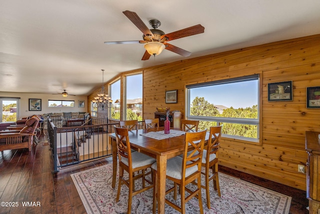 2335 Voyager Cir, Overgaard, AZ 85933 - dining room with ceiling fan, wooden walls, dark wood finished floors, and vaulted ceiling