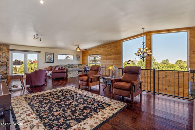 2335 Voyager Cir, Overgaard, AZ 85933 - living room featuring vaulted ceiling, wooden walls, hardwood / wood-style flooring, ceiling fan, and a chandelier