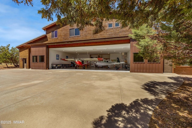 2335 Voyager Cir, Overgaard, AZ 85933 - view of front of house with board and batten siding, driveway, and a garage