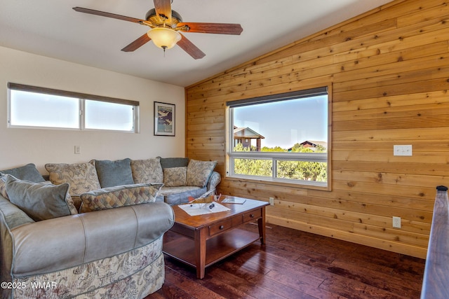 2335 Voyager Cir, Overgaard, AZ 85933 - living room featuring vaulted ceiling, wooden walls, plenty of natural light, dark wood-style flooring, and a ceiling fan