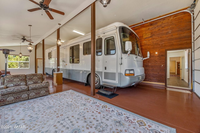 2335 Voyager Cir, Overgaard, AZ 85933 - living room featuring a ceiling fan, wood walls, and vaulted ceiling