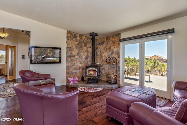 2335 Voyager Cir, Overgaard, AZ 85933 - living area featuring wood-type flooring, a wood stove, and baseboards