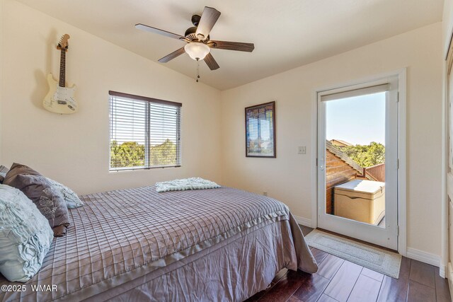 2335 Voyager Cir, Overgaard, AZ 85933 - bedroom with baseboards, wood finished floors, access to exterior, ceiling fan, and vaulted ceiling
