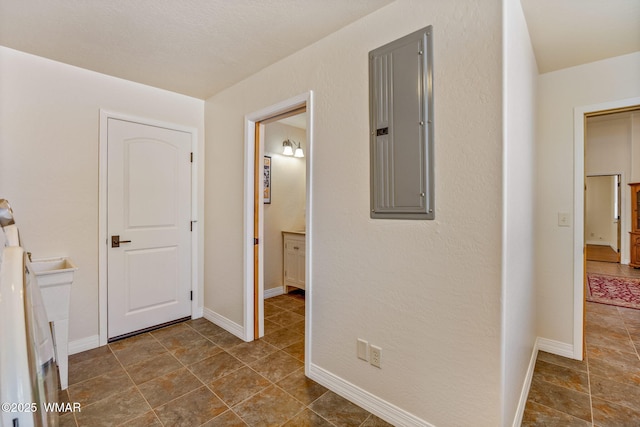 2335 Voyager Cir, Overgaard, AZ 85933 - hallway with electric panel, baseboards, and dark tile patterned floors
