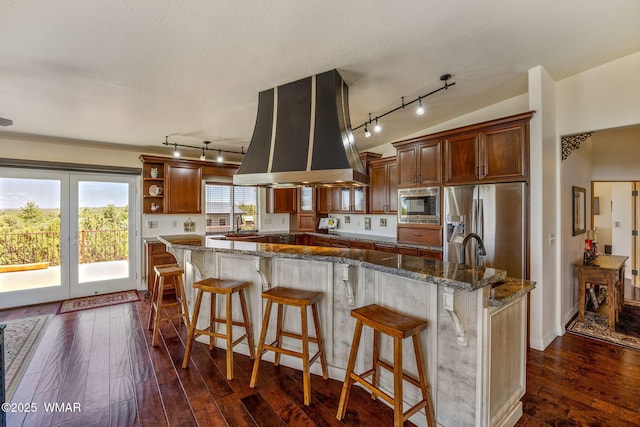 2335 Voyager Cir, Overgaard, AZ 85933 - kitchen with rail lighting, appliances with stainless steel finishes, island range hood, and dark wood-style floors