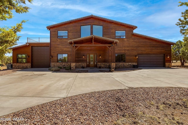 2335 Voyager Cir, Overgaard, AZ 85933 - chalet / cabin with concrete driveway, stone siding, and a balcony