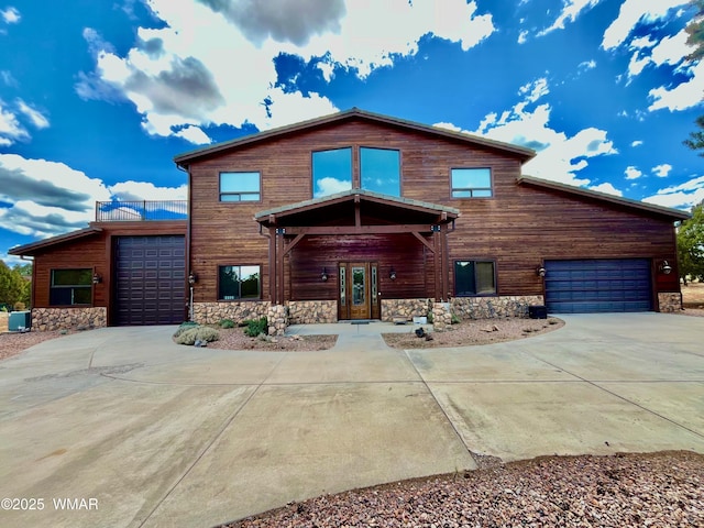 2335 Voyager Cir, Overgaard, AZ 85933 - view of front of property with driveway, stone siding, and a garage