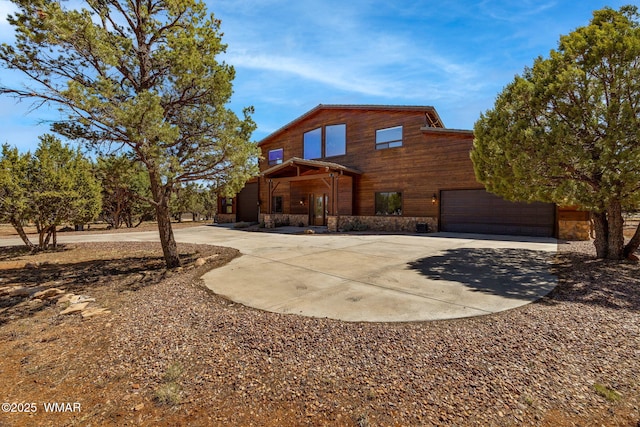 2335 Voyager Cir, Overgaard, AZ 85933 - view of front facade with driveway, an attached garage, and stone siding