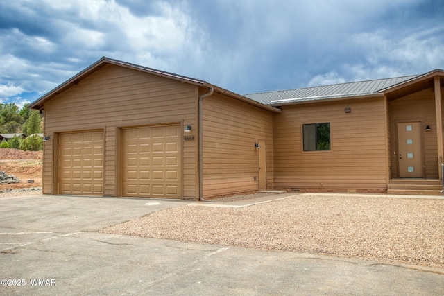 4668 W Tatanka Loop, Show Low, AZ 85901 - view of front of house featuring crawl space, driveway, metal roof, and an attached garage