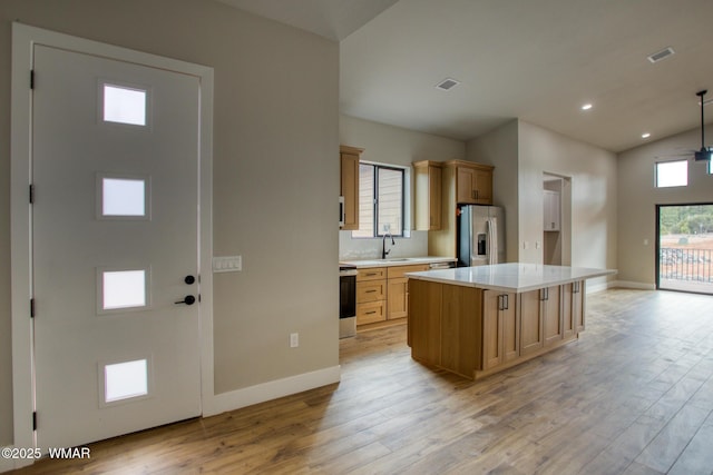 4668 W Tatanka Loop, Show Low, AZ 85901 - kitchen with appliances with stainless steel finishes, light wood-type flooring, light countertops, baseboards, and vaulted ceiling