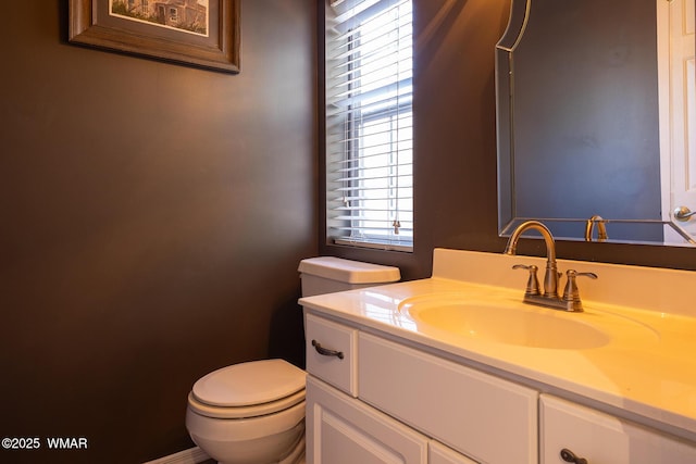 bathroom with toilet and vanity