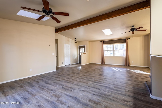 unfurnished living room with a ceiling fan, vaulted ceiling with skylight, baseboards, and wood finished floors