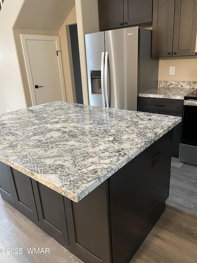 2426 Aspen Run, Pinetop, AZ 85935 - kitchen with a center island, appliances with stainless steel finishes, light stone counters, and wood finished floors