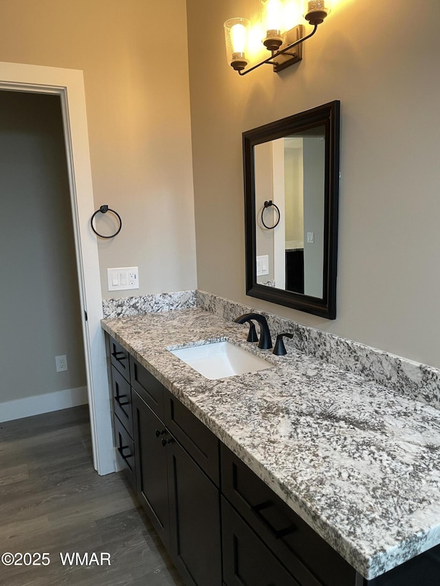 2426 Aspen Run, Pinetop, AZ 85935 - bathroom with an inviting chandelier, vanity, baseboards, and wood finished floors