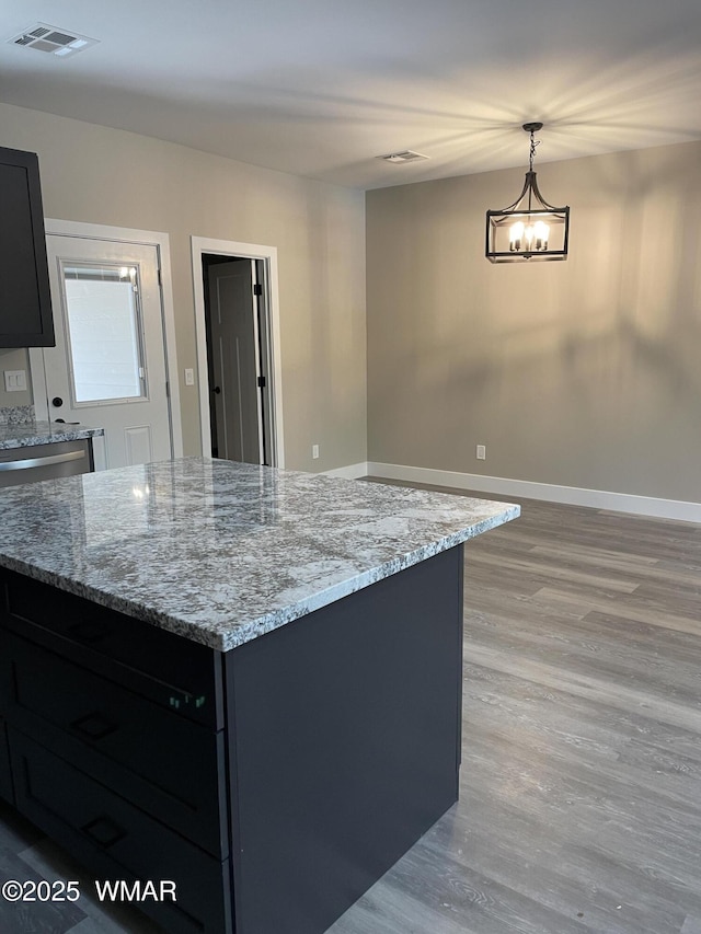 2426 Aspen Run, Pinetop, AZ 85935 - kitchen with visible vents, a chandelier, baseboards, light wood-style floors, and light stone counters