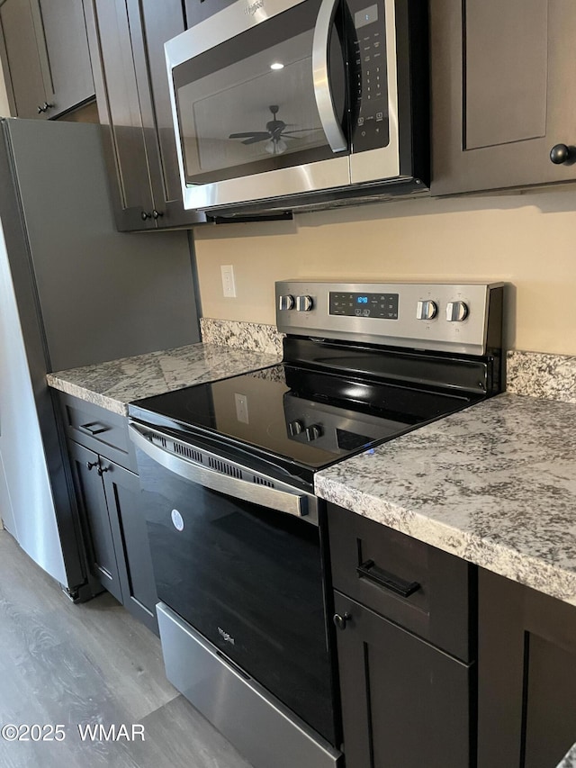 2426 Aspen Run, Pinetop, AZ 85935 - kitchen with light wood-type flooring, appliances with stainless steel finishes, and a ceiling fan