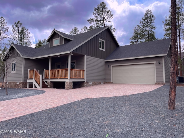 2426 Aspen Run, Pinetop, AZ 85935 - view of front of home featuring cooling unit, an attached garage, board and batten siding, decorative driveway, and a porch