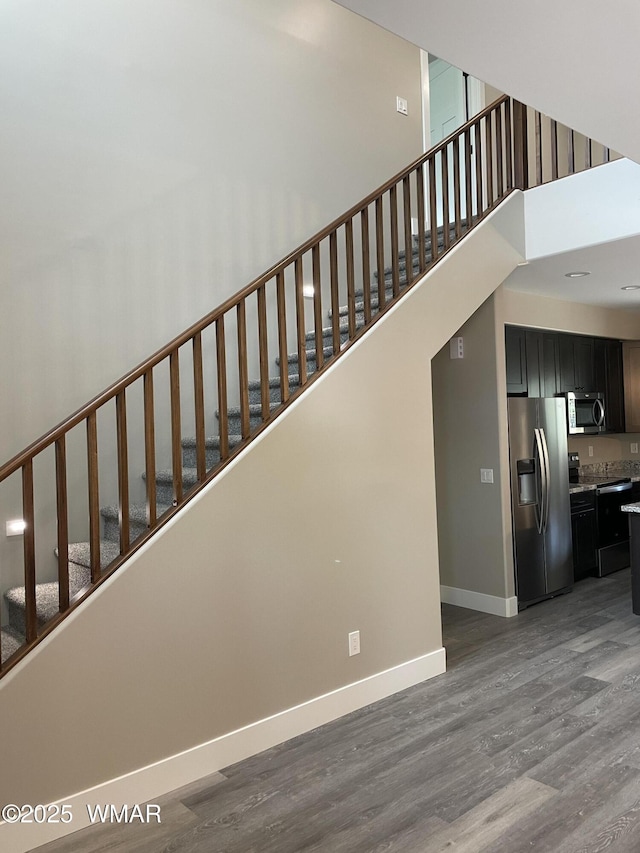 2426 Aspen Run, Pinetop, AZ 85935 - stairs featuring baseboards, wood finished floors, and a towering ceiling