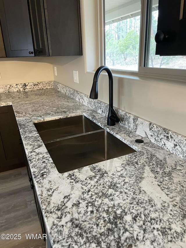 2426 Aspen Run, Pinetop, AZ 85935 - interior details featuring a sink, light stone counters, and wood finished floors