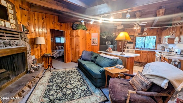 219 Yeager Ln, Lakeside, AZ 85929 - living area featuring a fireplace, wood walls, and a ceiling fan