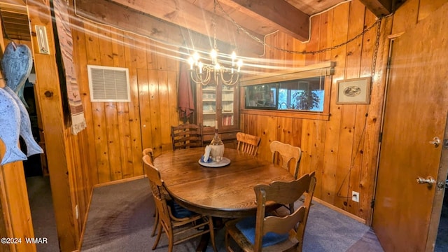 219 Yeager Ln, Lakeside, AZ 85929 - carpeted dining space featuring wooden walls, a chandelier, and beamed ceiling