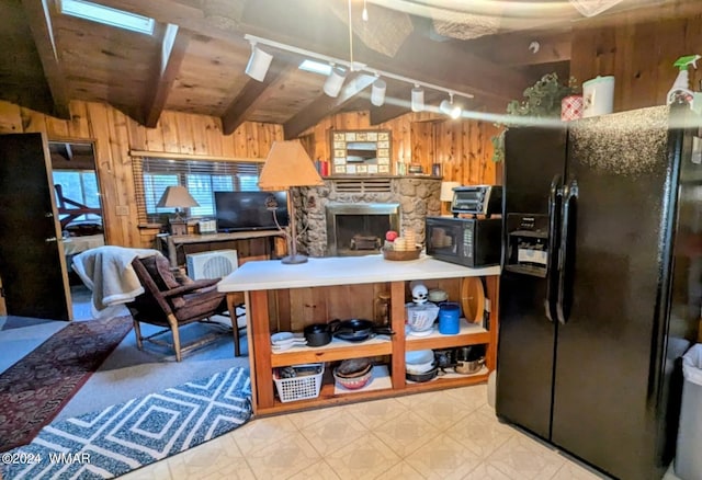 219 Yeager Ln, Lakeside, AZ 85929 - kitchen with wood walls, black appliances, a wood ceiling with exposed beams, tile patterned floors, and rail lighting