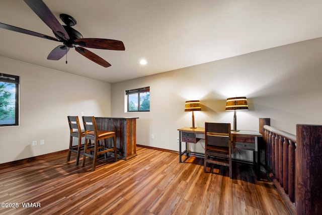 office with a bar, recessed lighting, wood finished floors, and baseboards